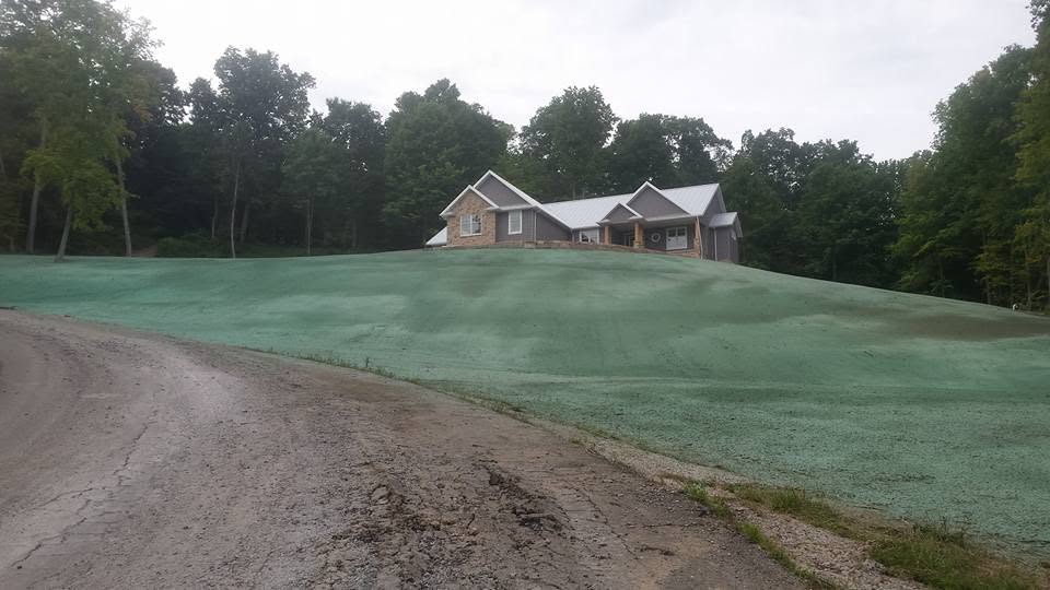 Same hillside after hydroseeding, green and established