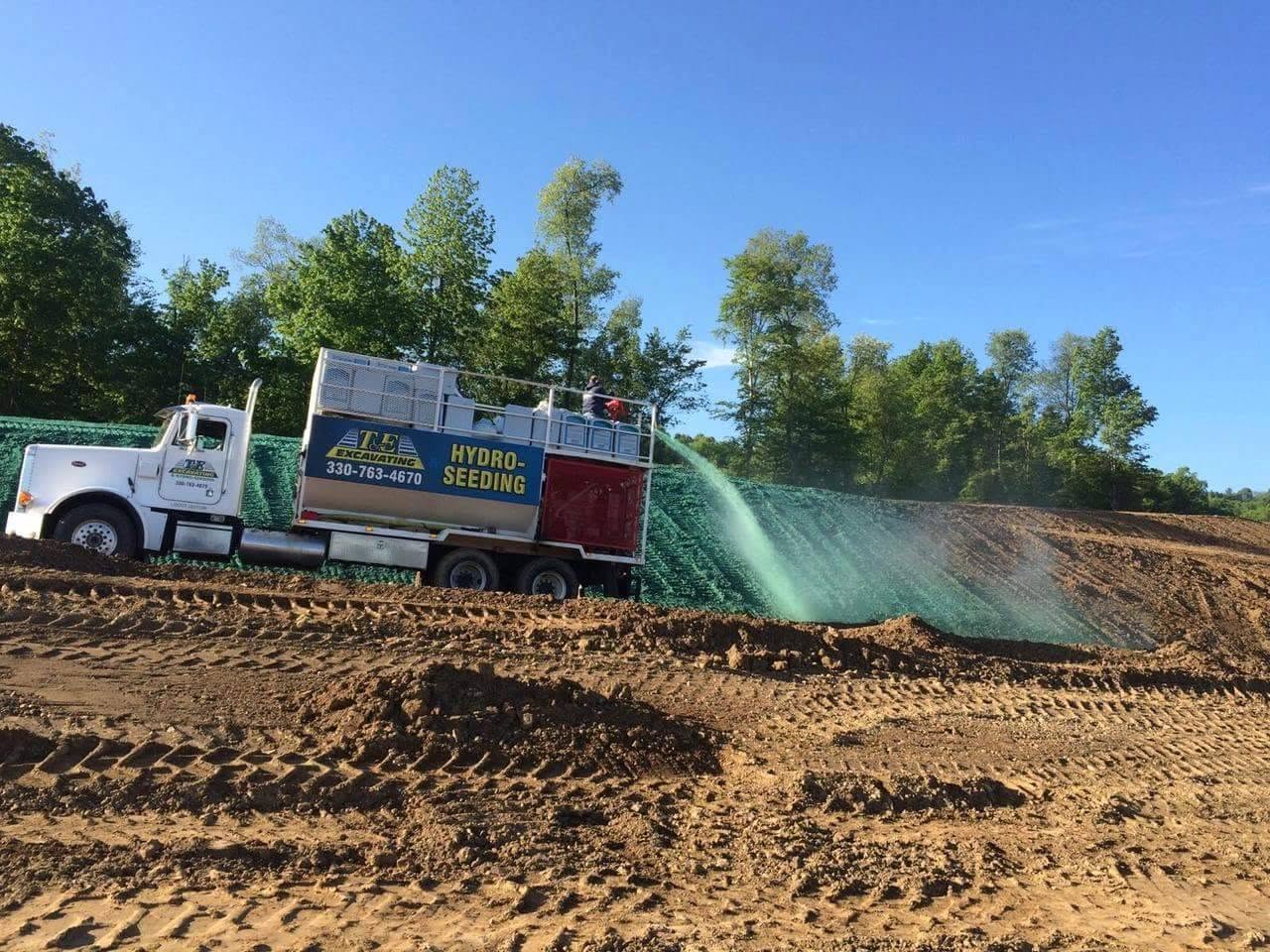 T&E hydroseeding truck spraying a steep slope