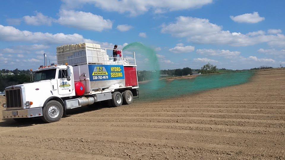 T&E hydroseeding truck spraying an open field